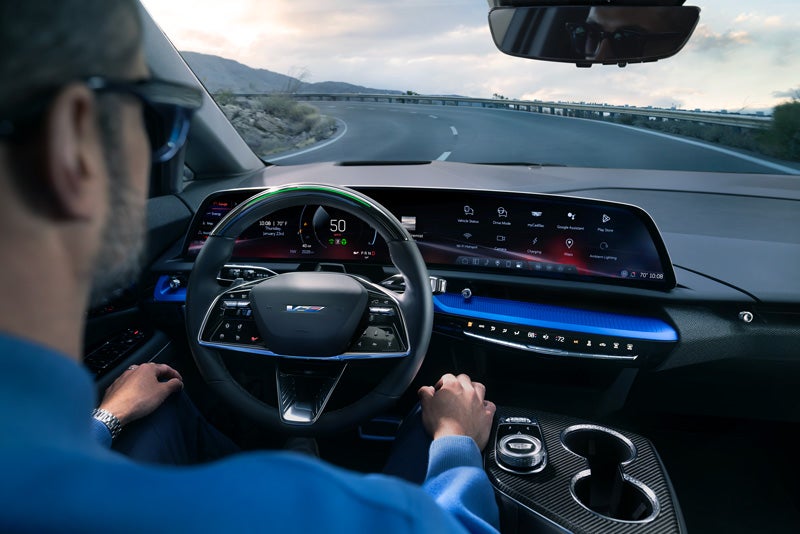 Front View of the 2026 OPTIQ-V Driving Through the Dusk Utilizing its Headlights | Leachman Cadillac in Bowling Green KY